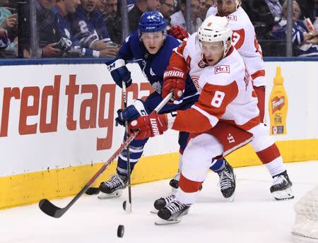 Oct 18, 2017; Toronto, Ontario, CAN; Detroit Red Wings forward Justin Abdelkader (8) skates the puck away from Toronto Maple Leafs defenceman Morgan Rielly (44) in the third period at Air Canada Centre. Mandatory Credit: Dan Hamilton-USA TODAY Sports