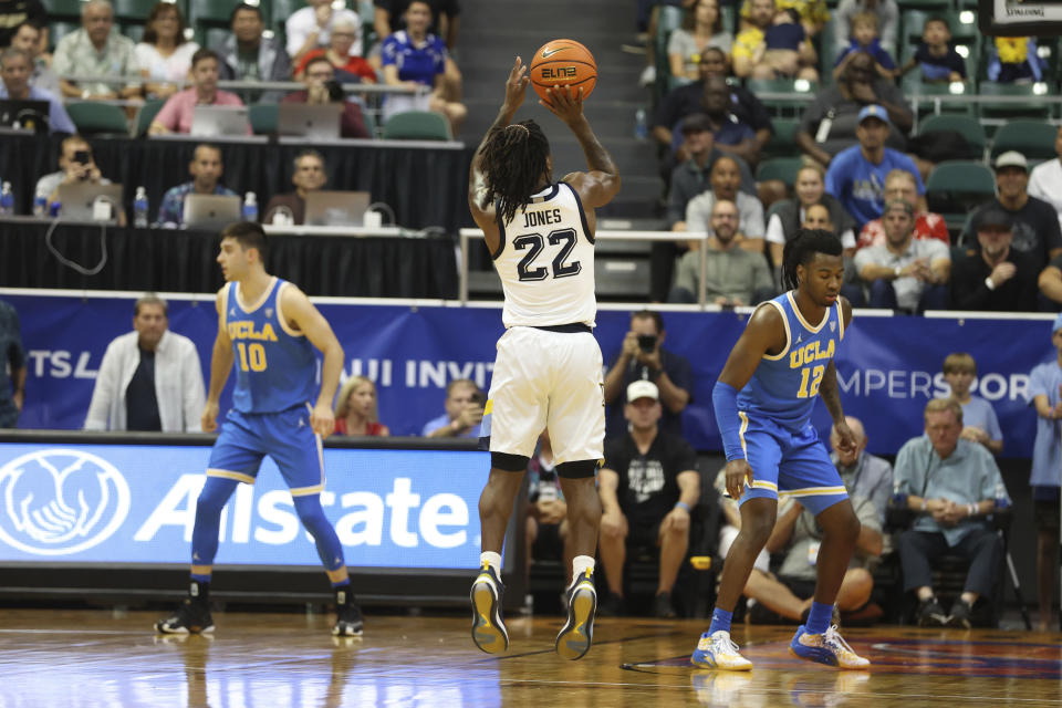 Marquette guard Sean Jones (22) makes a three point shot against UCLA during the second half of an NCAA college basketball game, Monday, Nov. 20, 2023, in Honolulu. Marquette defeated UCLA 71-69. (AP Photo/Marco Garcia)