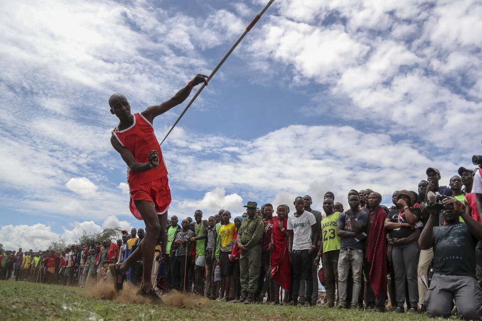 A Maasai man throws a javelin as he competes in the Maasai Olympics in Kimana Sanctuary, southern Kenya Saturday, Dec. 10, 2022. The sports event, first held in 2012, consists of six track-and-field events based on traditional warrior skills and was created as an alternative to lion-killing as a rite of passage. (AP Photo/Brian Inganga)