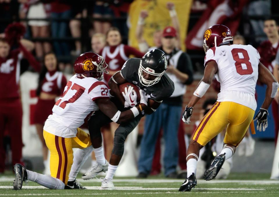 PULLMAN, WA – SEPTEMBER 29: Renard Bell #81 of the Washington State Cougars carries the ball against Aiene Harris #27 and Iman Marshall #8 of the USC Trojans in the first half at Martin Stadium on September 29, 2017 in Pullman, Washington. (Photo by William Mancebo/Getty Images)