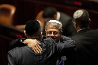 CORRECTS TO SWEARING-IN OF PARLIAMENT, NOT GOVERNMENT - Far-right Israeli lawmakers Itamar Ben Gvir hugs a colleague at the swearing-in ceremony for Israel's parliament, at the Knesset, in Jerusalem, Tuesday, Nov. 15, 2022. (AP Photo/ Maya Alleruzzo, Pool)