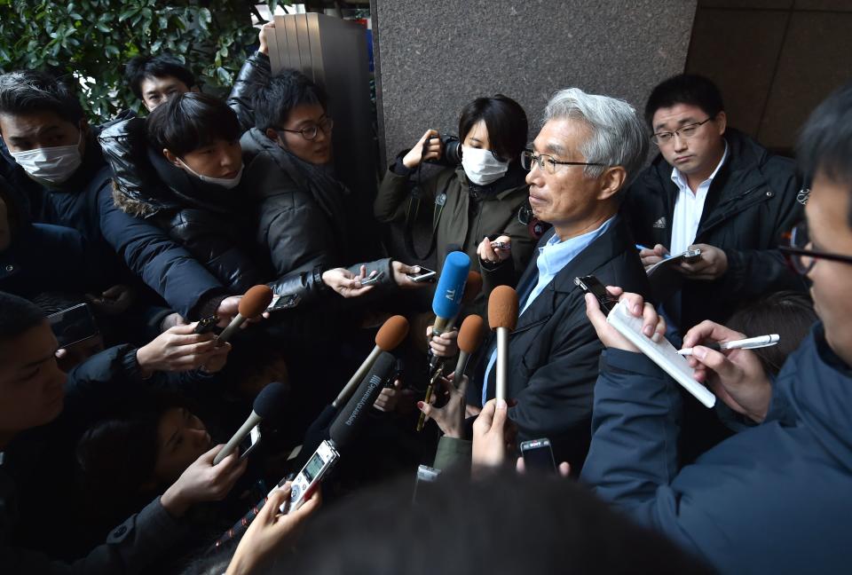 The Japanese lawyer for former auto tycoon Carlos Ghosn, Junichiro Hironaka (centre R), speaks to the media outside his office in Tokyo on December 31, 2019. - Ghosn said on December 31 he had "escaped injustice" in Japan, where he was on bail awaiting trial on financial misconduct charges, and had fled to Lebanon. (Photo by Kazuhiro NOGI / AFP) (Photo by KAZUHIRO NOGI/AFP via Getty Images)