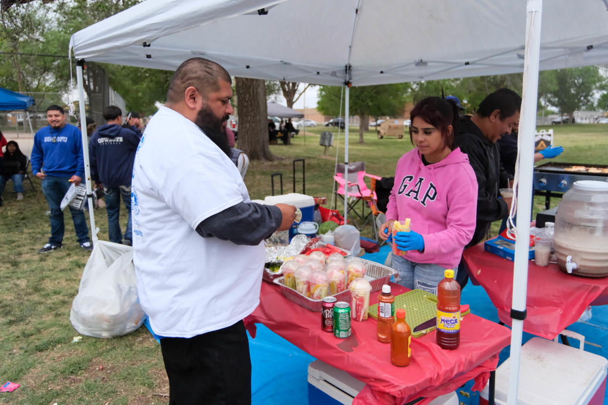Juan "Dash" Jimenez samples some food at the at the El Barrio Lions Club annual Cinco de Mayo Celebration at Alamo Park in Amarillo.