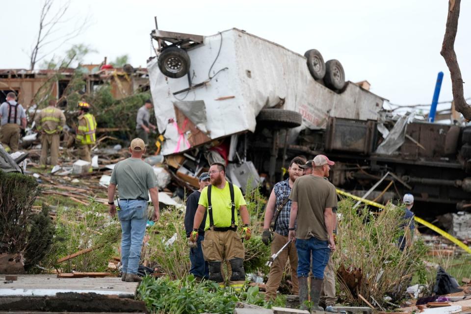 Workers search through remains of tornado-damaged home in Iowa (AP)