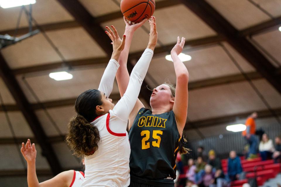 East's Emily Wierenga shoots over her Holland defender Friday, Feb. 10, 2023, at Holland High School. 