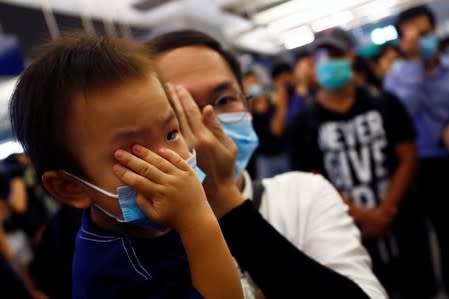 Protest at Yuen Long MTR station, the scene of an attack by suspected triad gang members a month ago