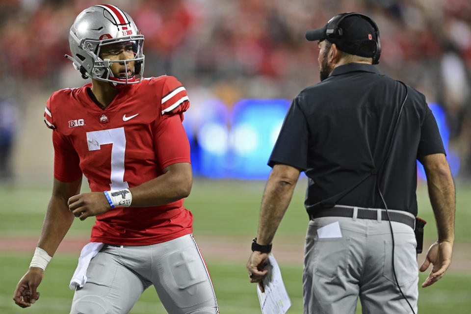 Ohio State quarterback C.J. Stroud, left, talks with head coach Ryan Day during the second quarter of an NCAA college football game against Notre Dame, Saturday, Sept. 3, 2022, in Columbus, Ohio. (AP Photo/David Dermer)