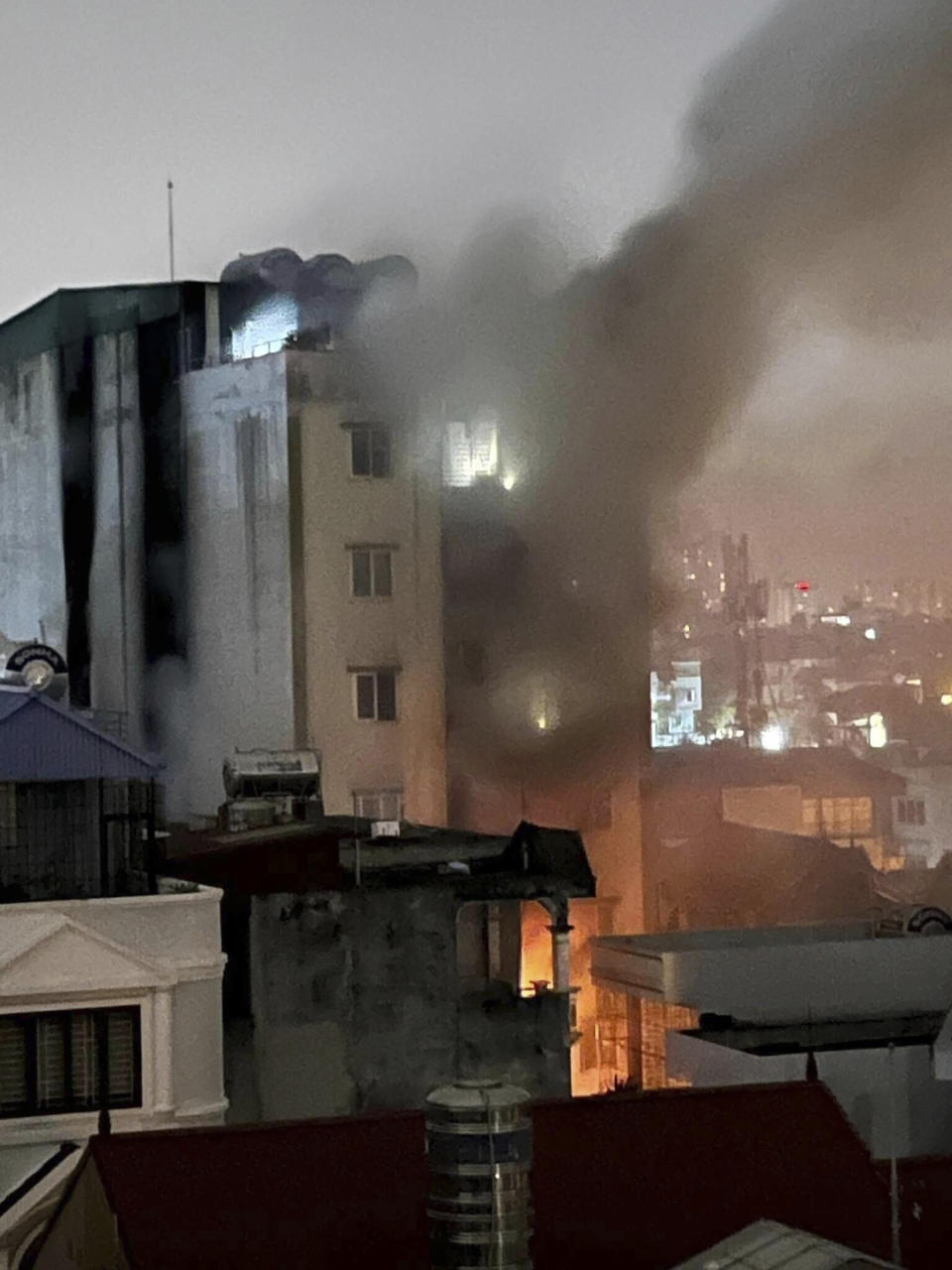 Smoke rises from a building in Hanoi, Vietnam Wednesday, Sept. 13, 2023. Authorities said "many" people had been killed after a fire broke out in the apartment block. (Nhan Huu Sang/ VNA via AP)