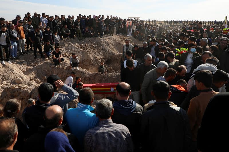 People gather during a funeral in Derik countryside