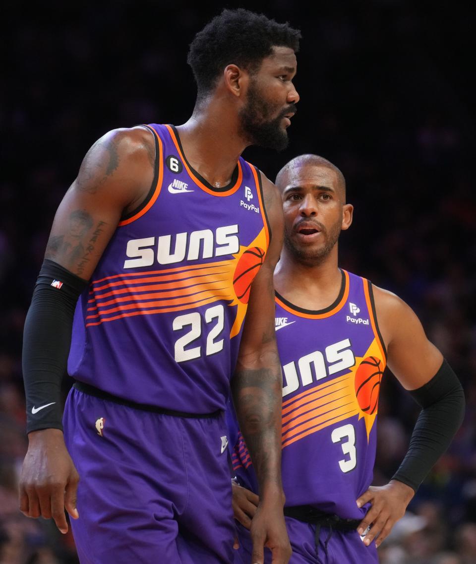 Phoenix Suns guard Chris Paul (3) talks to center Deandre Ayton (22) during their game against the Denver Nuggets at Footprint Center in Phoenix on March 31, 2023.
