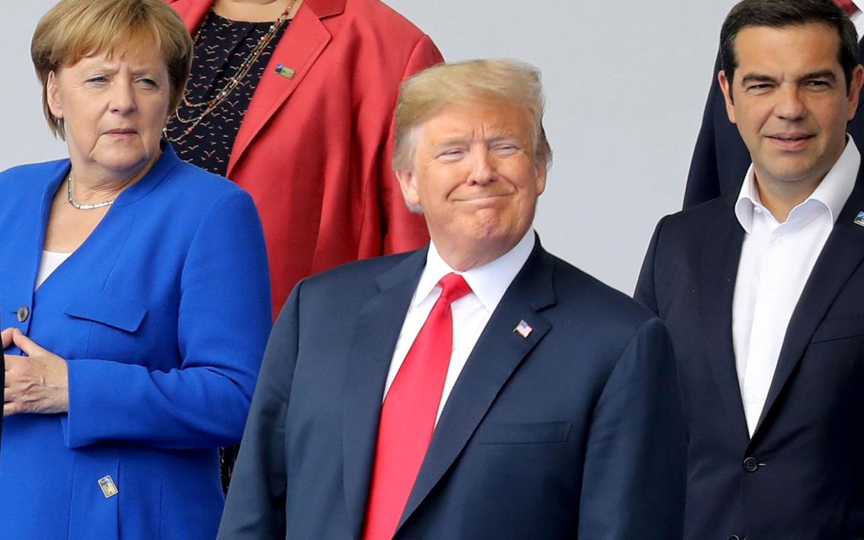 Angela Merkel and Donald Trump pose for a family photo ahead of the NATO opening ceremony - POOL AFP