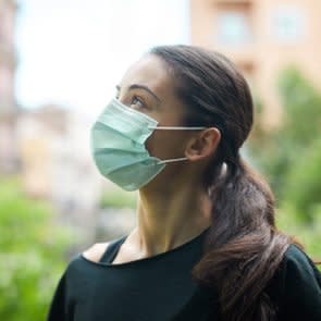 One young woman wearing a surgical mask outdoor