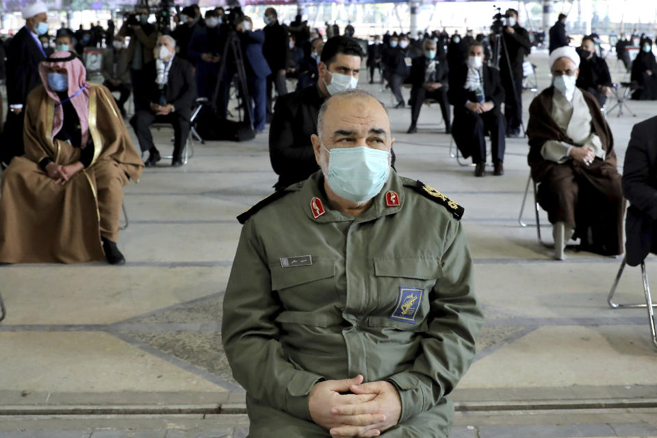 Chief of Iran's Revolutionary Guard Gen. Hossein Salami wearing a mask, attends a ceremony on the occasion of first anniversary of death of late Iranian Revolutionary Guards Corps (IRGC) general and commander of the Quds Force Qasem Soleimani, in Tehran, Iran, Friday, Jan. 1, 2021. The top commander of Iran's paramilitary Revolutionary Guard said Friday that his country was fully prepared to respond to any U.S. military pressure, amid heightened tensions between Tehran and Washington in the waning days of President Donald Trump's administration. (AP Photo/Ebrahim Noroozi)