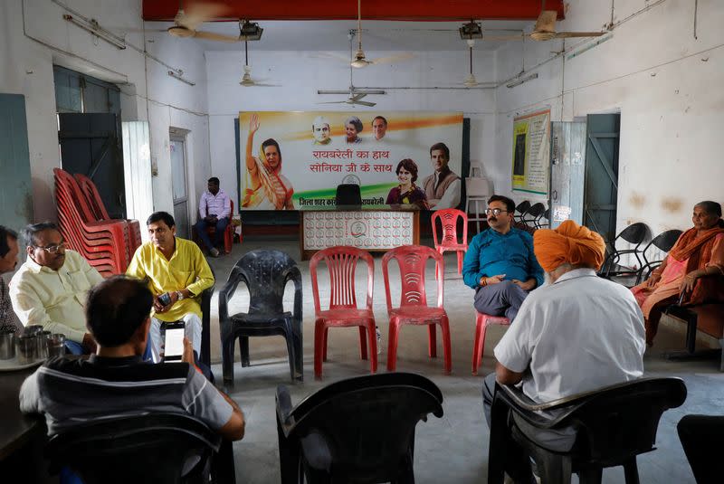 People sit inside a conference room inside India's main opposition Congress party's district office in Raebareli