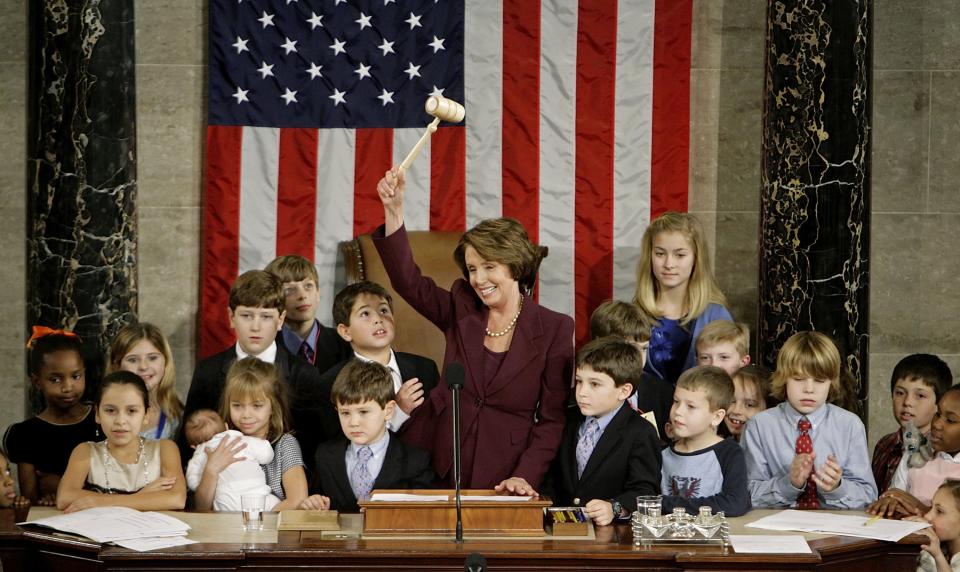 Speaker of the House Nancy Pelosi (D-CA) waves the Speaker's gavel while surrounded by her own grandchildren and the children of other members of Congress after being elected as the first woman Speaker at a swearing in ceremony for the 110th Congress in the House Chamber of the U.S. Capitol January 4, 2007 in Washington, DC. (Photo by Chip Somodevilla/Getty Images)