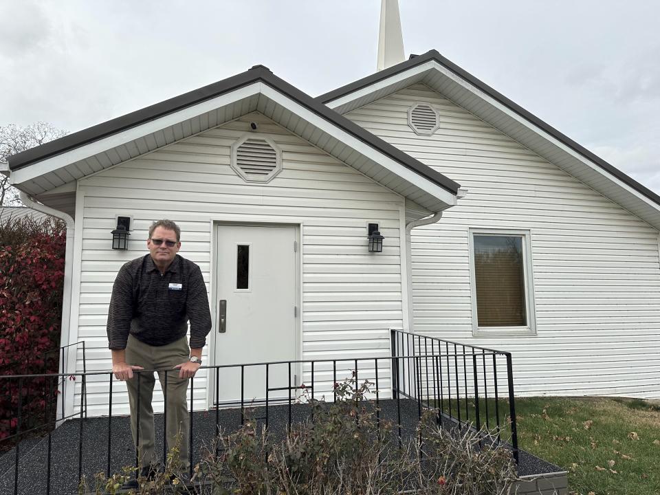 Pastor Kenny Batson stands near the entrance of Grace Fellowship Church on Nov. 16, 2023, in El Dorado Springs, Mo. Batson was convicted of a series of crimes in the 1990s but became a Christian pastor after being released from prison. He was pardoned by Missouri Gov. Mike Parson. (AP Photo/David A.Lieb)