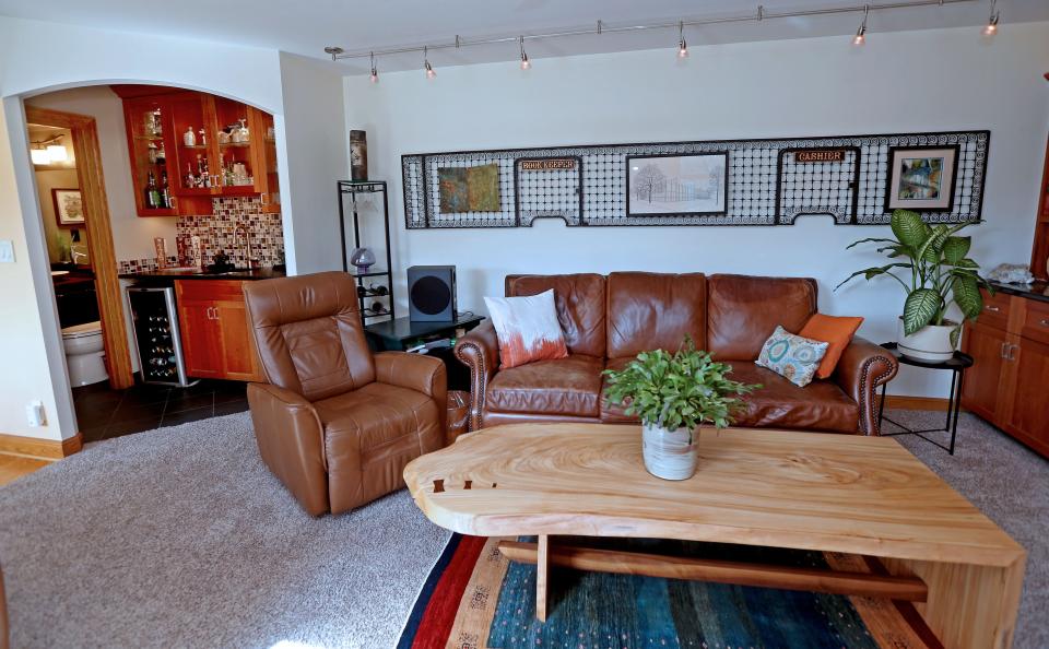 The family room of Bayside homeowners Linda Even and Scott Kania features an old bank teller's cage repurposed as art.