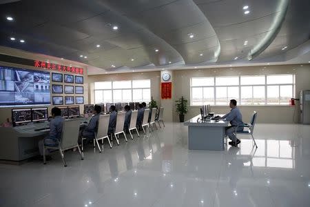 Employees work inside a newly launched waste-to-energy plant by Suzhou Wujiang Everbright Environmental Energy Ltd in Wujiang of Suzhou, Jiangsu province, China, November 8, 2016. Picture taken November 8, 2016. REUTERS/Aly Song