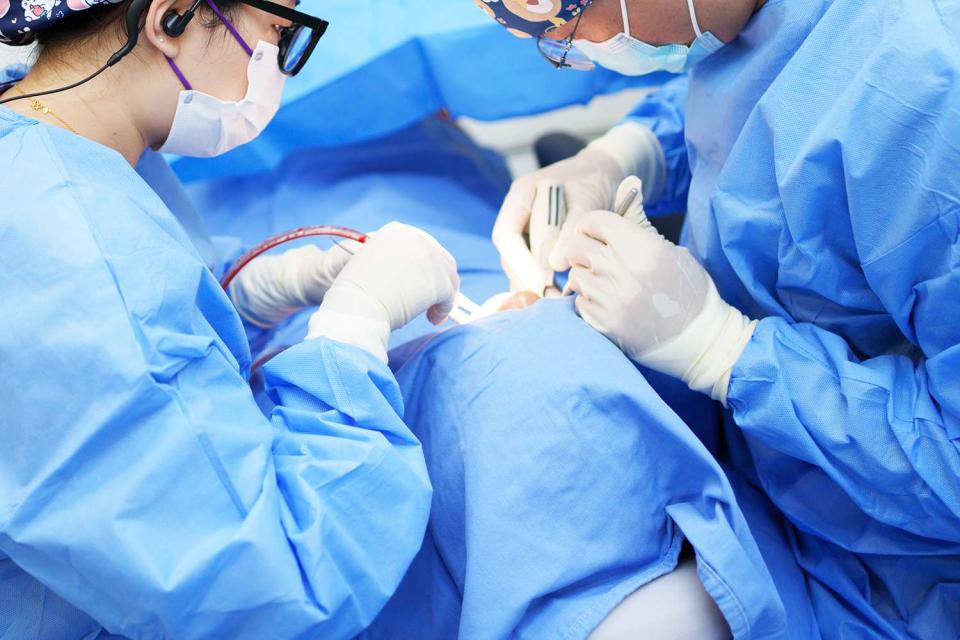 <p>Wengen Ling/Getty</p> Stock photo of a a man undergoing surgery