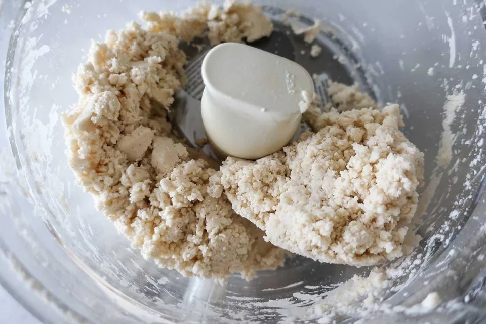 pie crust dough being made in a food processor