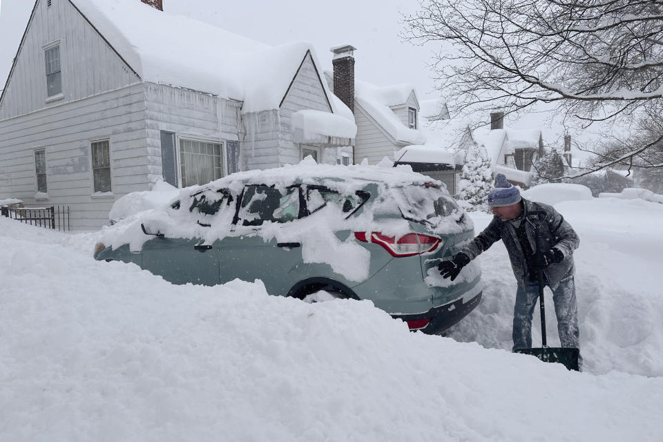 Patrick Sahr shovels snow in Buffalo, N.Y., Wednesday, Jan. 17, 2024. Heavy lake-effect snow was forecast in Buffalo, with up to 4 inches an hour expected through the afternoon. City hall was closed, and school districts declared snow days. Travel bans were issued for several suburbs. The winter blast comes days after a storm that delayed an NFL playoff game for a day. (AP Photo/Carolyn Thompson)