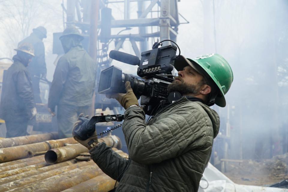 A cameraman shoots oil workers in "How America Works."