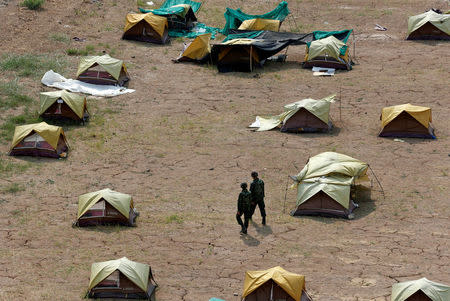 Soldiers walk among tents on the premises of the Wat Phra Dhammakaya temple during an inspection of the temple, in Pathum Thani province, Thailand March 10, 2017. REUTERS/Chaiwat Subprasom