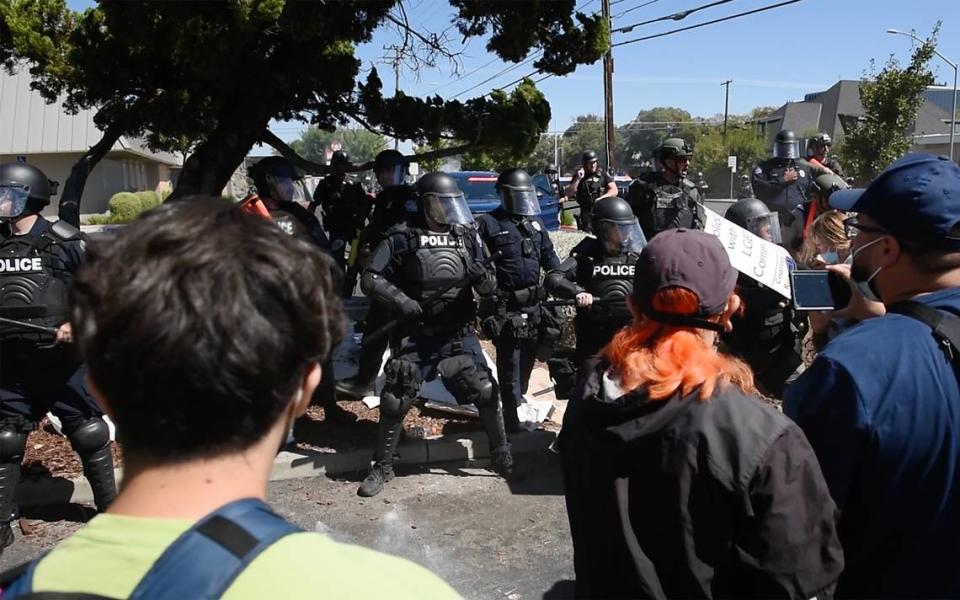 Modesto Police try and clear the area around the Planned Parenthood office on McHenry Ave during an opposition rally that began as a protest to the Straight Pride event in Modesto, Calif., on Saturday, August 27, 2022.