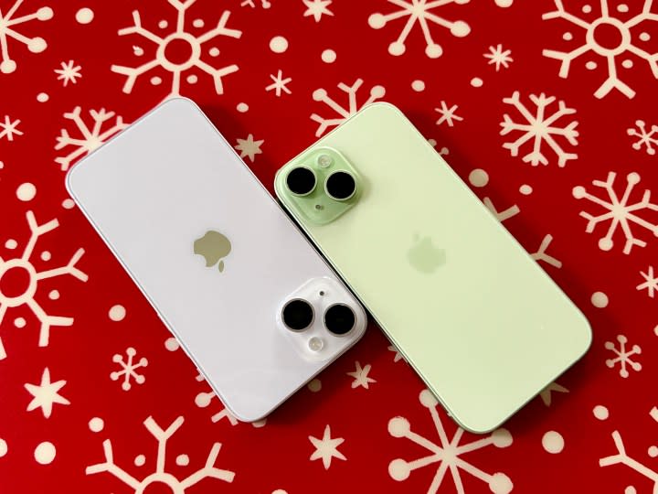 Purple iPhone 14 (left) and a green iPhone 15.