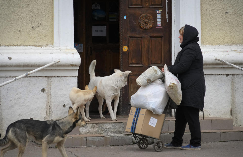 A woman waits for free bread in Bakhmut, the site of the heaviest battle against the Russian troops in the Donetsk region, Ukraine, Friday, Oct. 28, 2022. (AP Photo/Efrem Lukatsky)