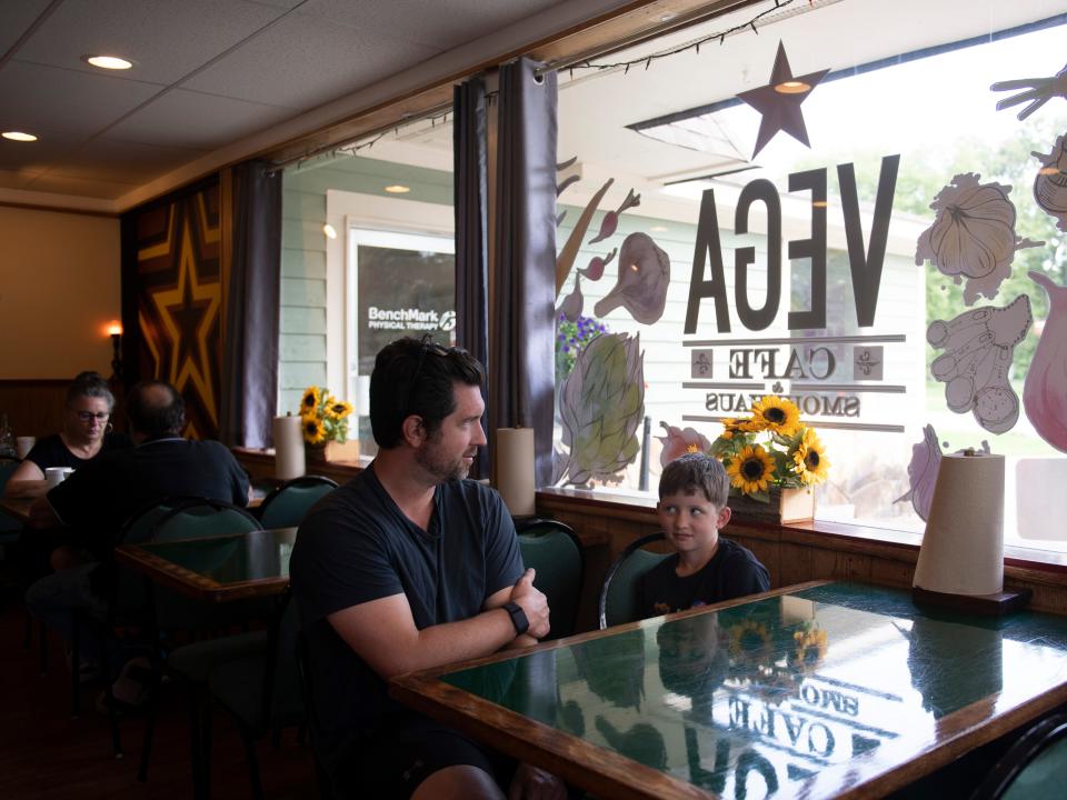 Danny Peavy and son Griffin wait for their to-go order at VEGA Cafe & Smokehaus in Norris, Tenn. on Thursday, July 21, 2022. It is their second visit to the restaurant in two days. 