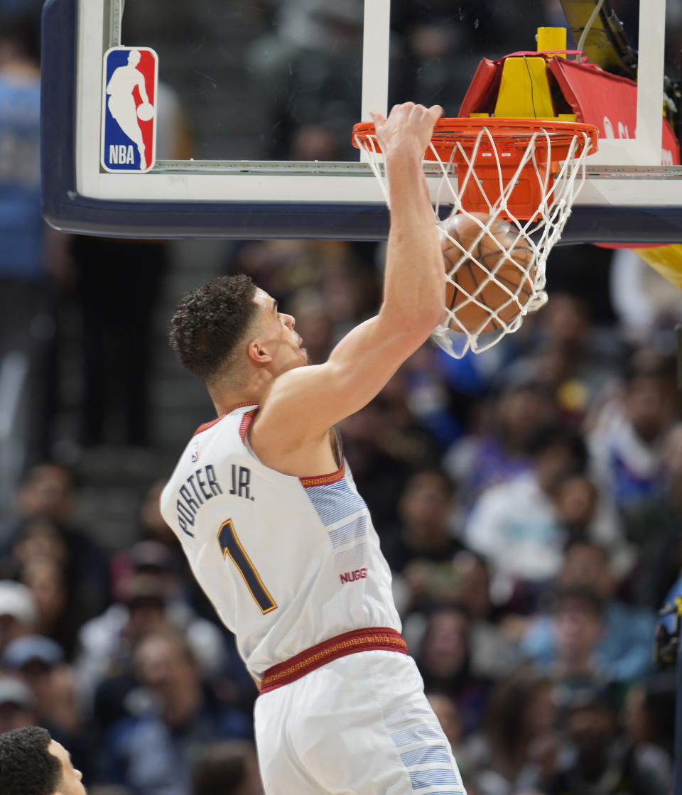 Denver Nuggets forward Michael Porter Jr. dunks for a basket against the Toronto Raptors in the first half of an NBA basketball game Monday, March 6, 2023, in Denver. (AP Photo/David Zalubowski)