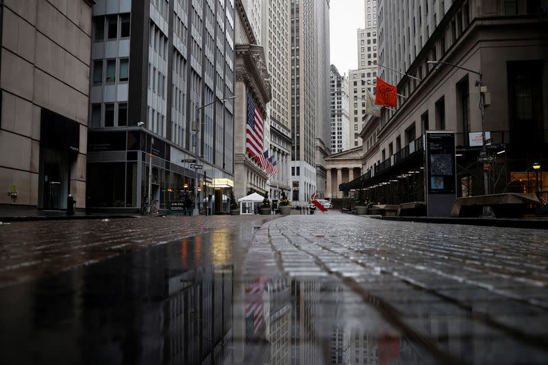 A view of a nearly deserted Broad street and and the New York Stock Exchange in the financial district of lower Manhattan in New York