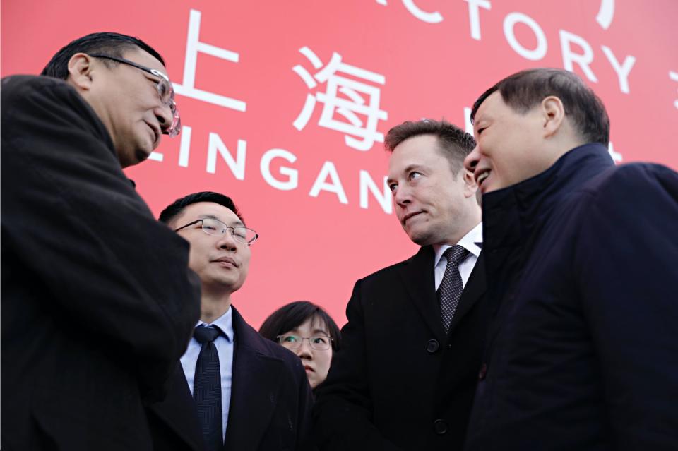 Robin Ren, vice president of sales at Tesla Inc., left, speaks with Elon Musk, chief executive officer, second right, and Ying Yong, mayor of Shanghai, right, following an event at the site of the company's manufacturing facility in Shanghai, China, on Monday, Jan. 7, 2019. (Photo: Qilai Shen/Bloomberg via Getty Images) 