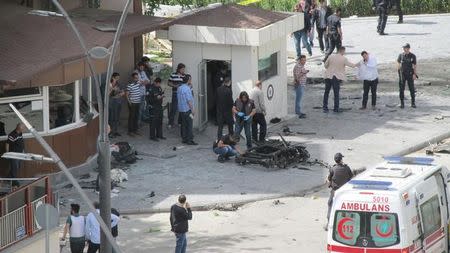 Police forensic experts inspect the scene after an explosion in front of the city's police headquarters in Gaziantep, Turkey May 1, 2016. Ihlas News Agency via REUTERS