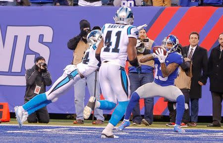 Dec 20, 2015; East Rutherford, NJ, USA; New York Giants wide receiver Odell Beckham (13) catches a touchdown pass against Carolina Panthers cornerback Josh Norman (24) with less than 2 minutes to play to tie the sore at MetLife Stadium. Mandatory Credit: Jim O'Connor-USA TODAY Sports