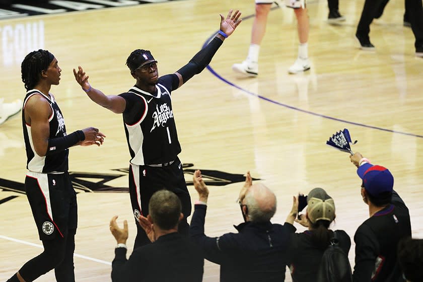 The Clippers' Reggie Jackson, right, and Terance Mann are cheered during Friday's game.