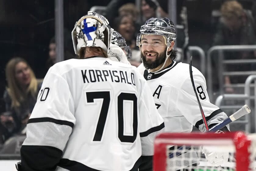 Los Angeles Kings defenseman Drew Doughty, right, smiles as goaltender Joonas Korpisalo.