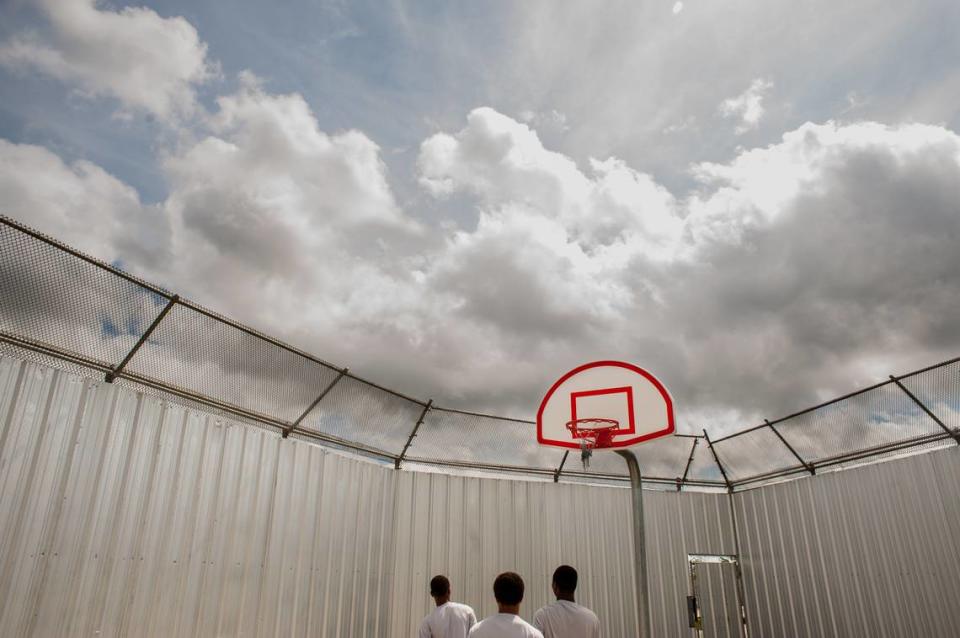 This image of teen boys playing basketball was taken at the Youth Study Center juvenile detention facility in New Orleans is in the “W|ALLS” exhibit.