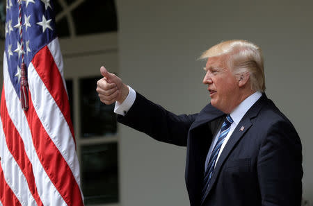 U.S. President Donald Trump gives a thumbs up during a National Day of Prayer event at the Rose Garden of the White House in Washington D.C., U.S., May 4, 2017. REUTERS/Carlos Barria