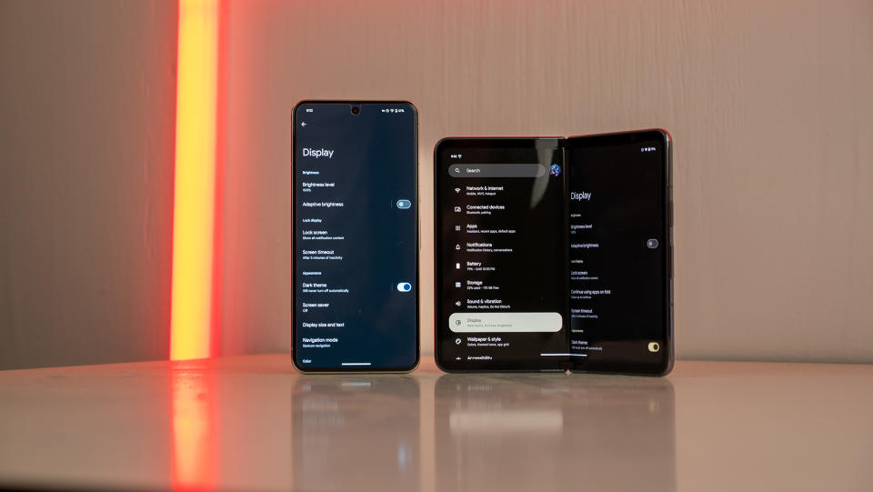 A Google Pixel 8 Pro and Google Pixel Fold using Android 15's dark mode