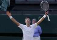 Novak Djokovic of Serbia celebrates defeating Roger Federer of Switzerland in their men's singles final tennis match at the Wimbledon Tennis Championships, in London July 6, 2014. REUTERS/Suzanne Plunkett