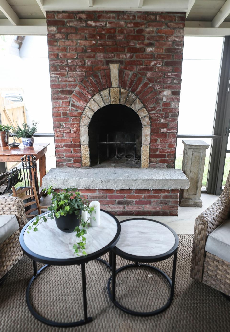 The recently-built back porch on the Sage's home was built for around $17,000 and features a brick fireplace, wood flooring and screens for a three-season area.