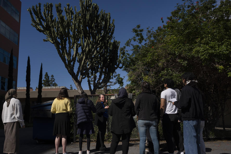 Associate professor Vered Mirmovitch, center, leads her biology class students on a botanical tour on the West Los Angeles College campus in Culver City, Calif., Tuesday, March 12, 2024. As students consider jobs that play a role in solving the climate crisis, they’re looking for meaningful climate training and community colleges are responding. (AP Photo/Jae C. Hong)