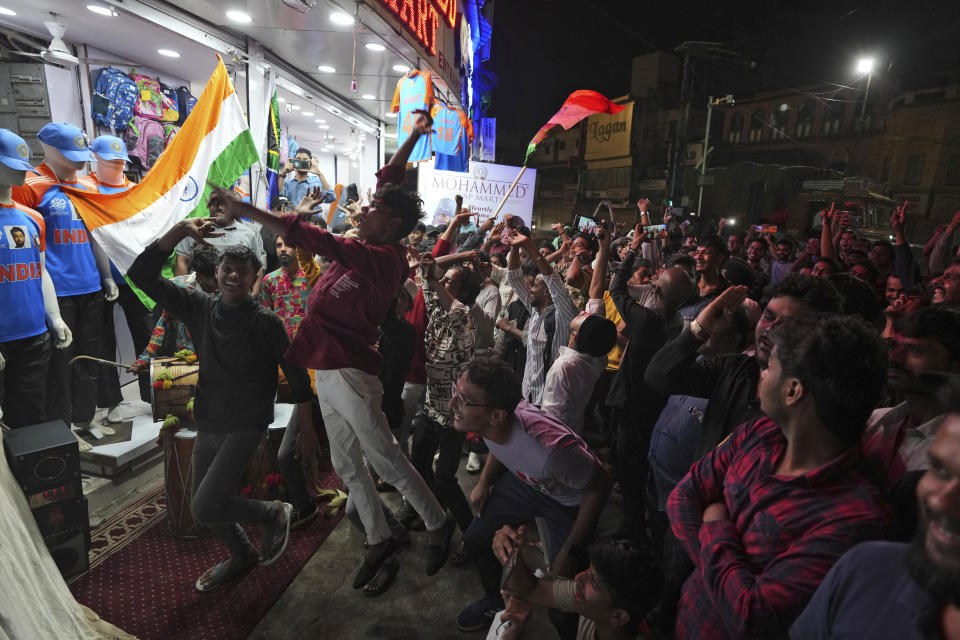 Cricket fans cheer while watching a broadcast of the ICC T20 World Cup final match between India and South Africa in Barbados, in Hyderabad, India, Saturday, June 29, 2024. (AP Photo/Mahesh Kumar A.)