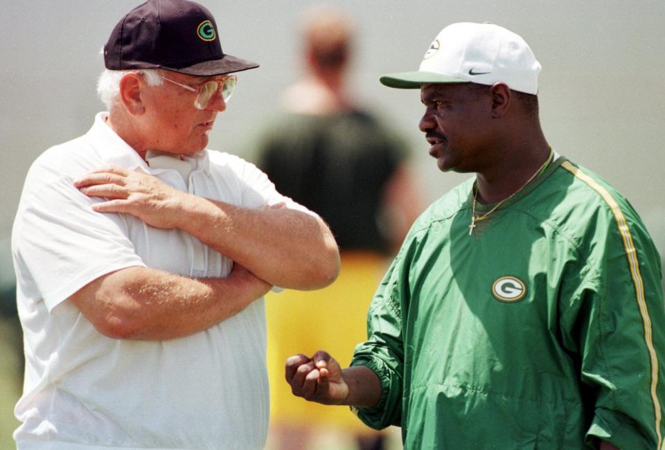 New Packers coach Ray Rhodes, right, talks with Glory Years guard Fuzzy Thurston, who was used to an intense coach, during a minicamp practice earlier this year.