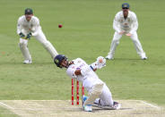 India's Washington Sundar ducks to avoid a bouncer during play on day three of the fourth cricket test between India and Australia at the Gabba, Brisbane, Australia, Sunday, Jan. 17, 2021. (AP Photo/Tertius Pickard)
