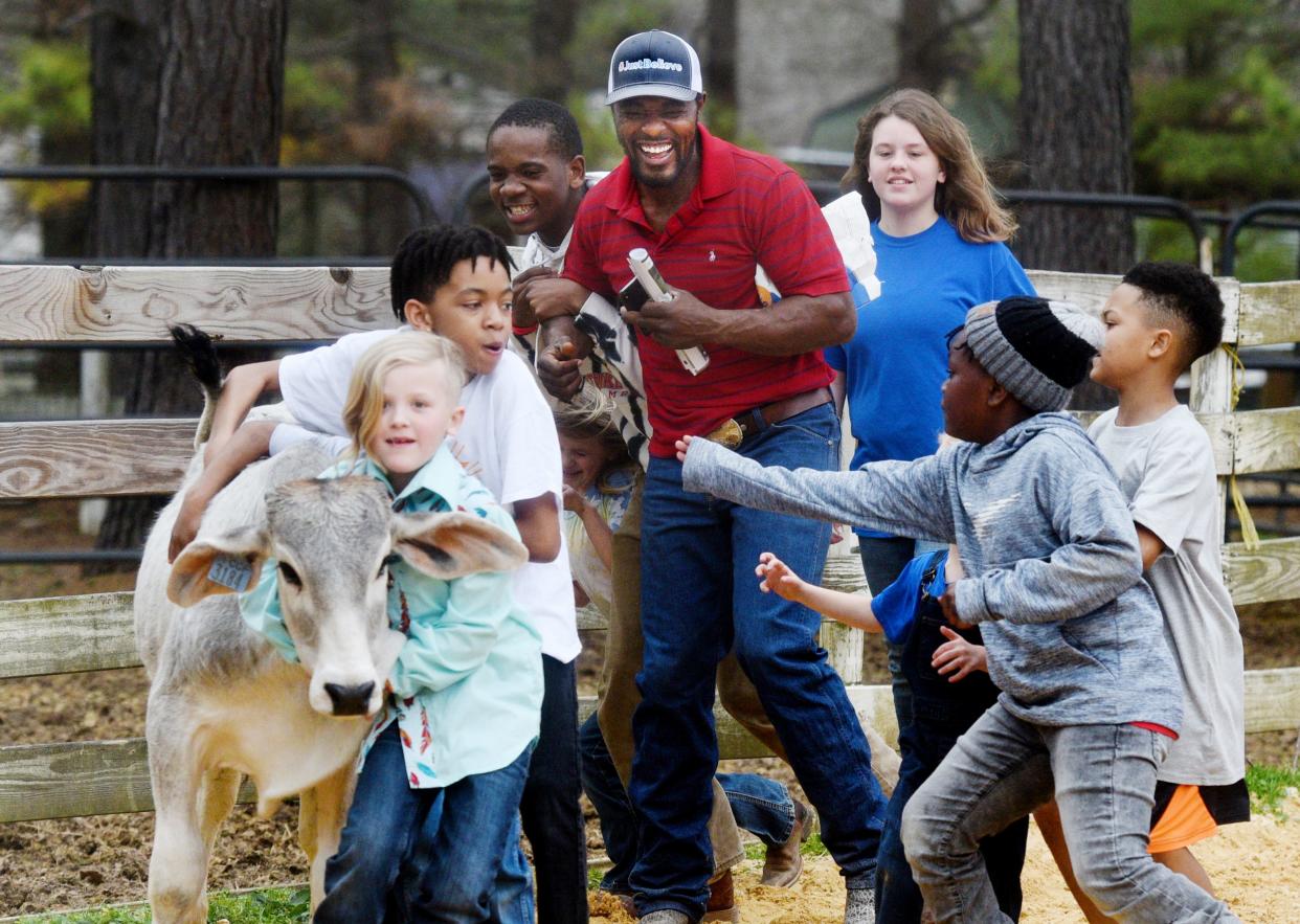 Jamon Turner (center) laughs as kids play Tic Tac Toe with cows during his Western Play Day, Just Believe, Saturday, March 5, 2022 at his ranch in Haughton. 