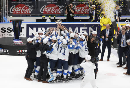 Ice Hockey World Championships - Final - Canada v Finland - Ondrej Nepela Arena, Bratislava, Slovakia - May 26, 2019 Finland's players hold a trophy as they celebrate after winning the World Championship. REUTERS/Vasily Fedosenko
