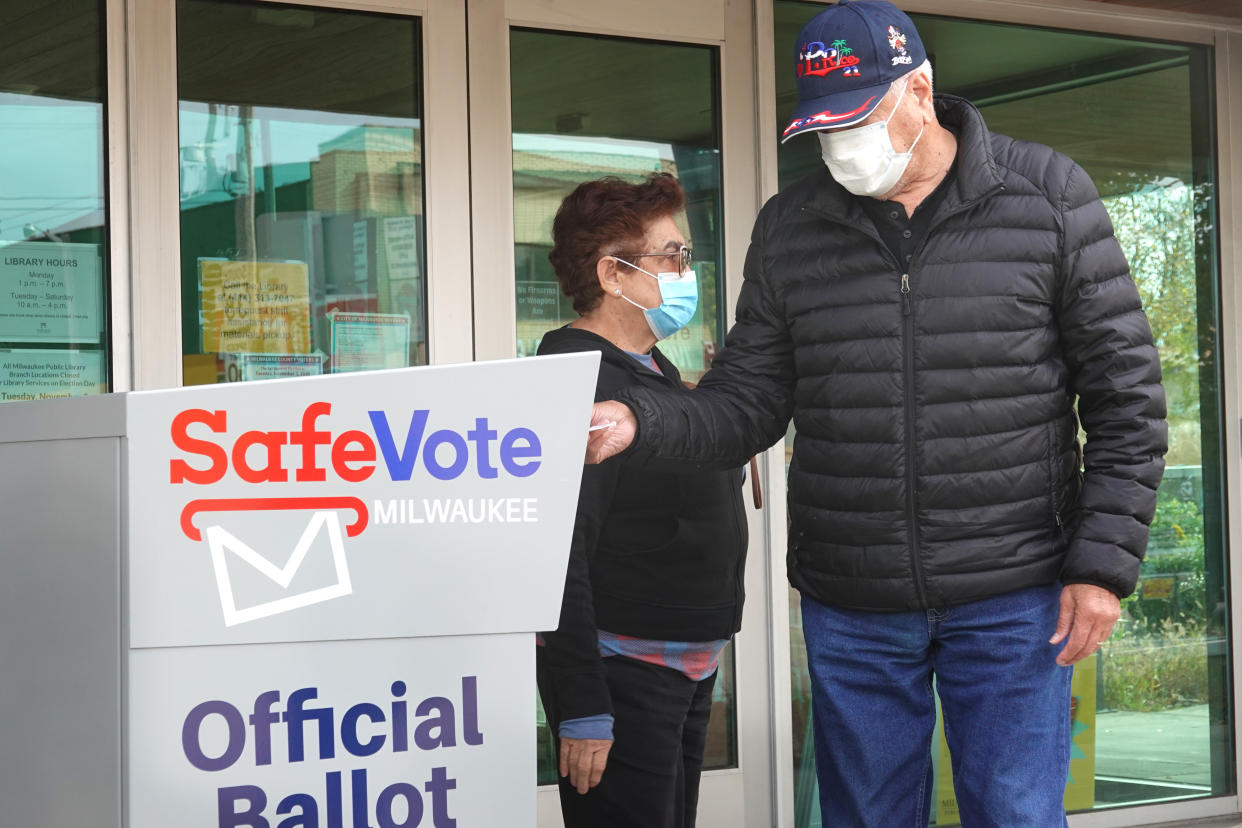 Residents drop mail-in ballots in an official ballot box outside of the Tippecanoe branch library on October 20, 2020 in Milwaukee, Wisconsin. (Scott Olson/Getty Images)